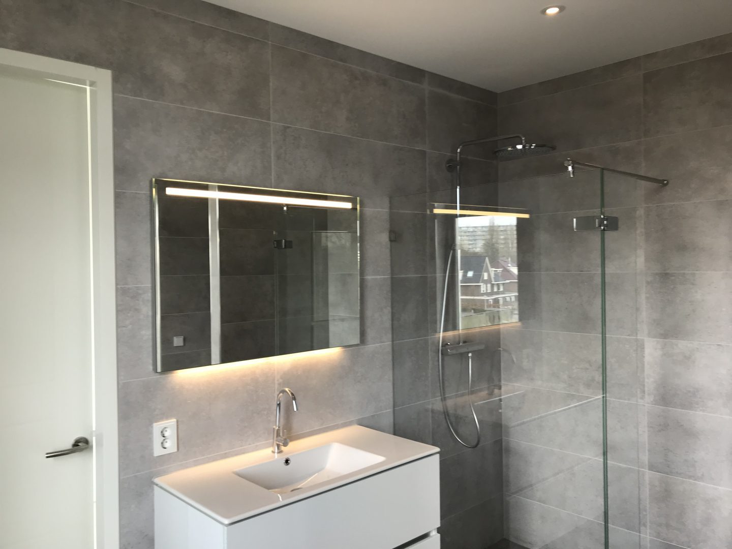 Impressie van badkamer met spanplafond met verlichting